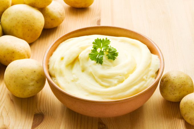 Bowl with mashed potatoes decorated with potatoes.
