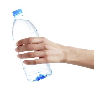 Hand holding a bottle of water. Isolated on white background. XXXL