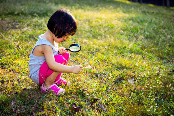 Asian Chinese Little Girl Exploring With Magnifying Glass
