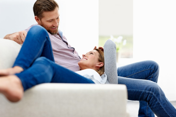 Smiling couple relaxing at home