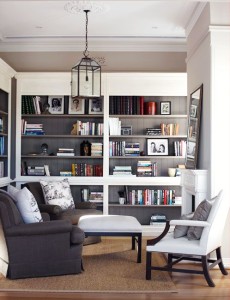 29-Cool-Built-In-Bookshelves-Ideas-With-grey-wooden-bookshelves-and-sofa-pillow-chair-and-candle-lantern-and-brown-rug-and-wooden-floor