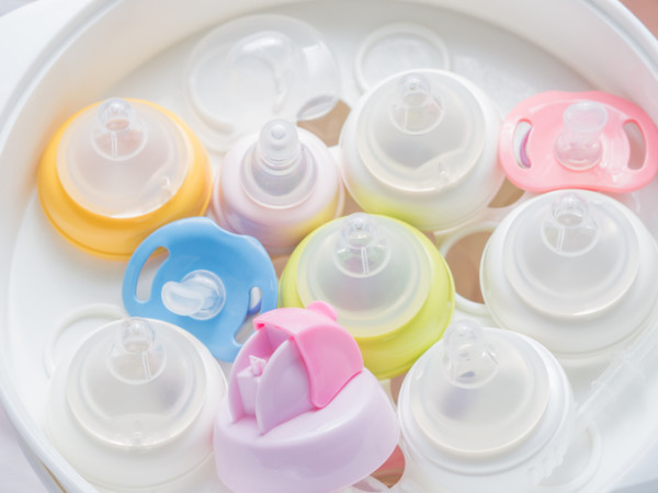 Nipple teethers and milk bottles in steam sterilizer and dryer.